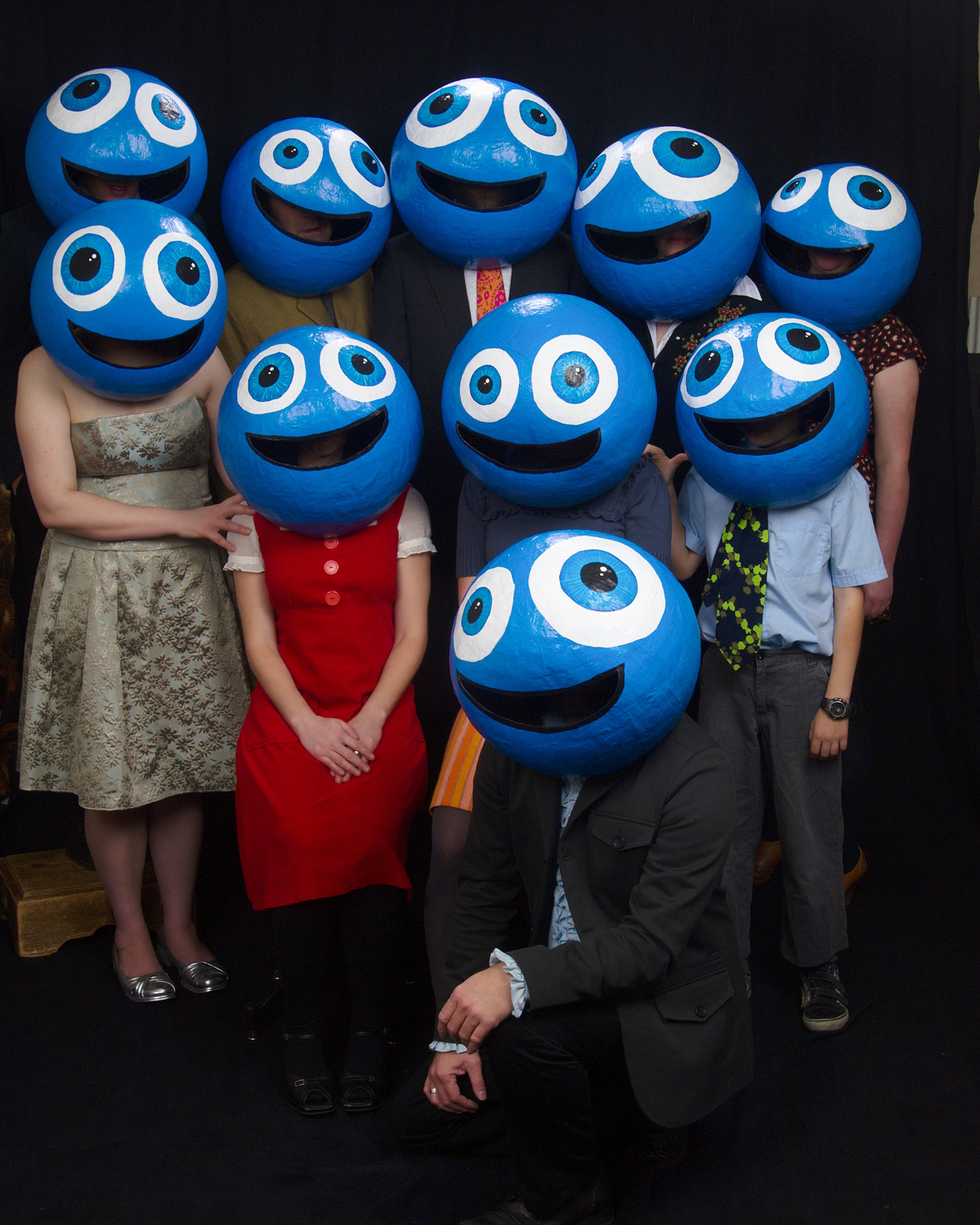 A group of people wearing the same smiley face masks that the Bran Flakes have worn.